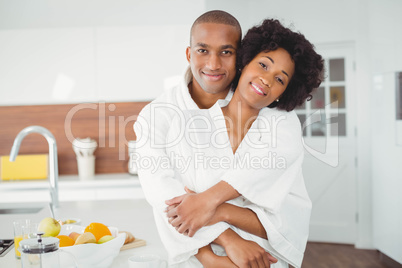 Happy couple hugging in the kitchen