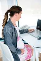 pregnant business woman on her laptop