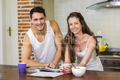 young couple checking their personal organizer in morning