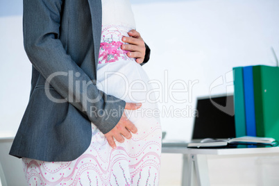 pregnant business woman holding her baby bmp