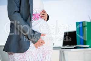 pregnant business woman holding her baby bmp