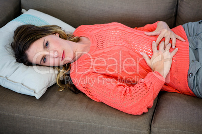 woman lying down holding her stomach