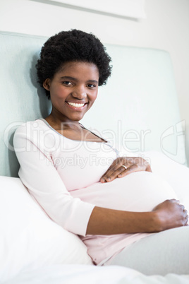 Pregnant woman touching her belly