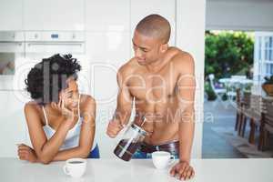 Happy couple drinking coffee in the kitchen