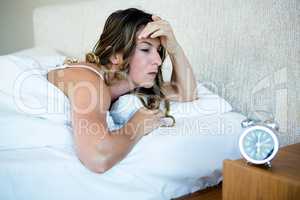 woman in her bed looking stressed