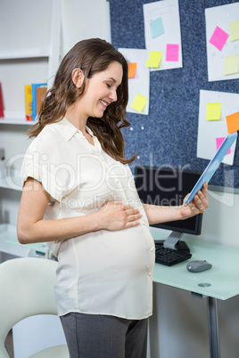 Pregnant woman using tablet