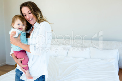 smiling woman holding an adorable baby