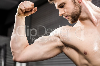 Shirtless man flexing biceps