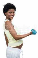 Pregnant woman lifting dumbbell