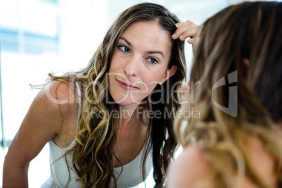 smiling woman fixing her hair