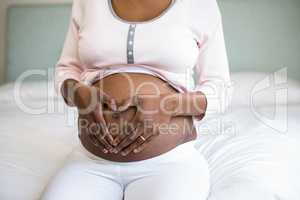 Pregnant woman doing heart shape