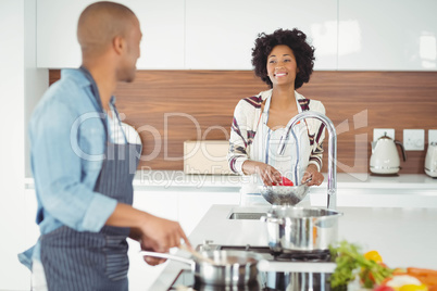 Happy couple preparing meal