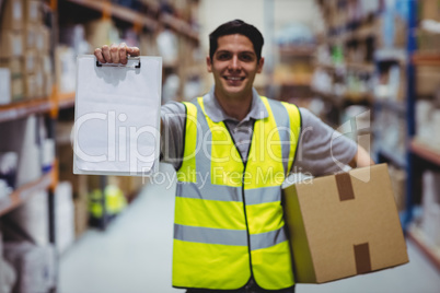 Smiling worker showing clipboard