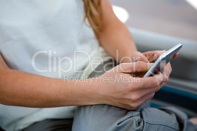 female hands typing on a mobile phone