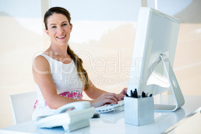 smiling businesswoman on her computer