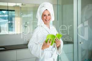 woman in a dressing gown reading a book