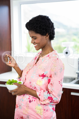 Pregnant woman eating salad