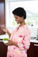 Pregnant woman eating salad