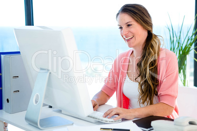 smiling businesswoman on her computer