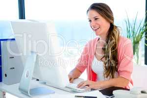 smiling businesswoman on her computer