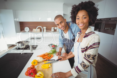 Happy couple preparing vegetables