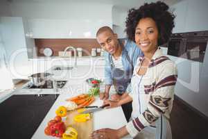 Happy couple preparing vegetables