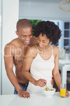 Happy couple eating breakfast in the kitchen