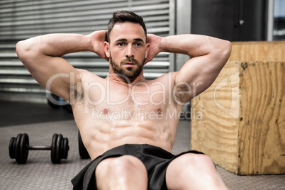 Shirtless man doing abdominal crunches