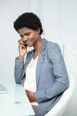 Pregnant businesswoman on the phone