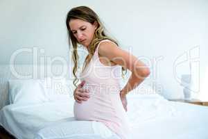 sad pregnant woman with back pain