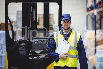 Portrait of warehouse worker with clipboard