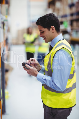 Warehouse worker using hand scanner