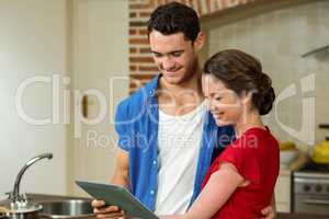 Young couple looking at digital tablet