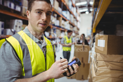 Warehouse worker scanning box