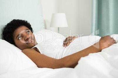 Pregnant woman resting on bed