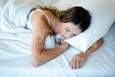 peaceful woman asleep in her bed