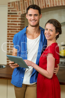 Young couple looking at digital tablet