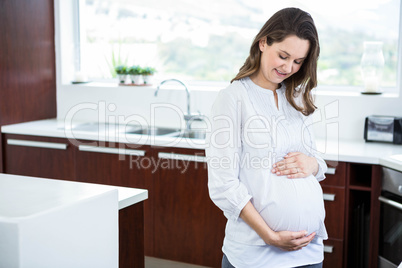 Pregnant woman touching her belly