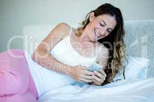 smiling woman playing on her  mobile phone