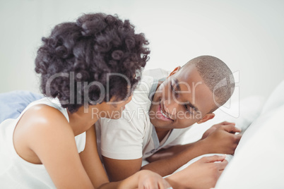 Smiling couple lying on the bed