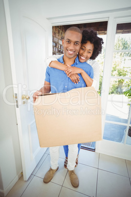 Happy couple holding box
