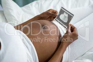 Pregnant woman looking at ultrasound picture
