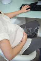 Pregnant woman using computer