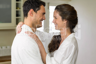 Young couple in bathrobe embracing each other Young couple in bathrobe embracing each other