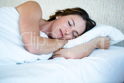 peaceful woman asleep in her bed