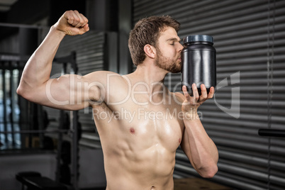 Shirtless man showing biceps and kissing can