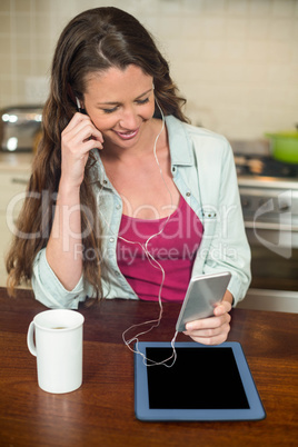 Young woman listening to music on smartphone