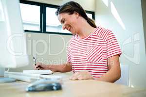 smiling business woman writing in a notepad
