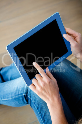 finger tapping a touchscreen tablet