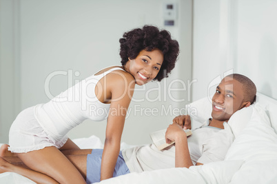 Happy couple reading on the bed